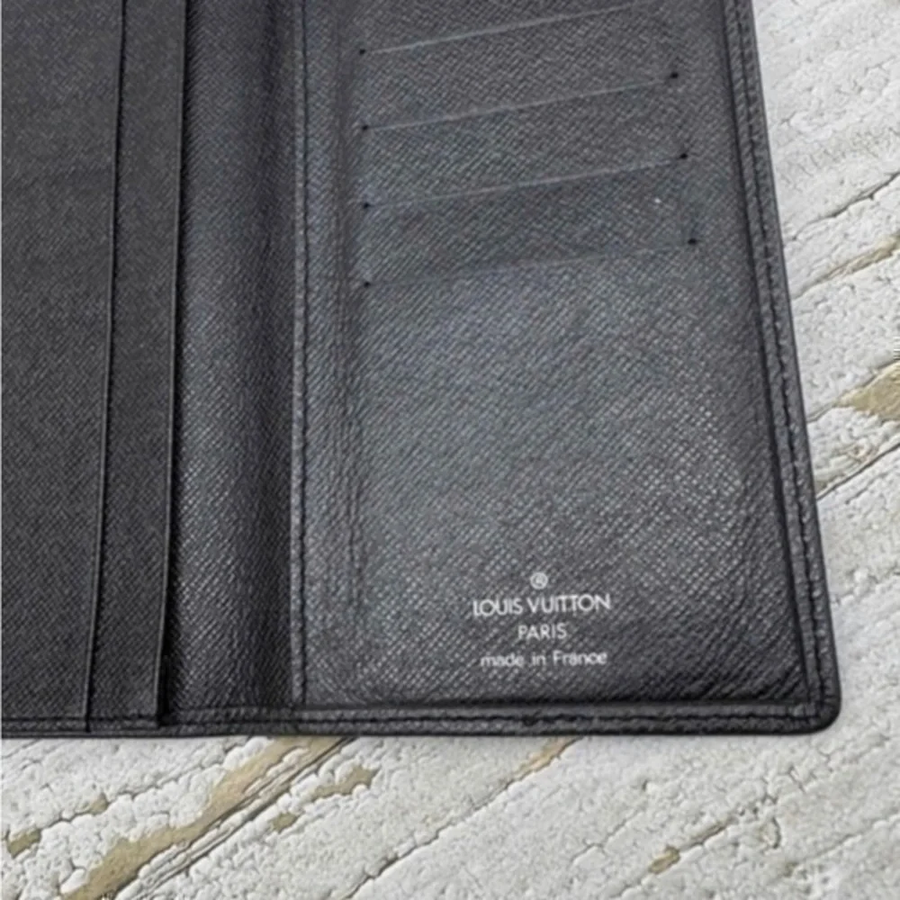 AUTHENTIC Louis Vuitton Taiga wallet. Previously owned. Color: Black.